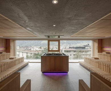 Sauna mit Panoramablick im Feldhof Eine moderne Sauna mit Holzbänken und großen Fenstern mit Blick über Naturns.